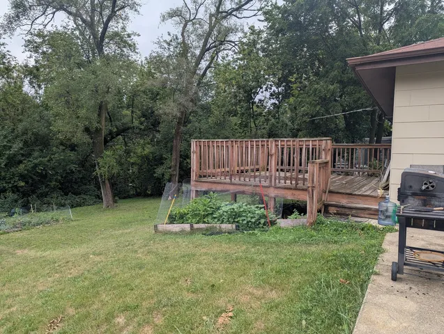 a view of a chair and table in the backyard
