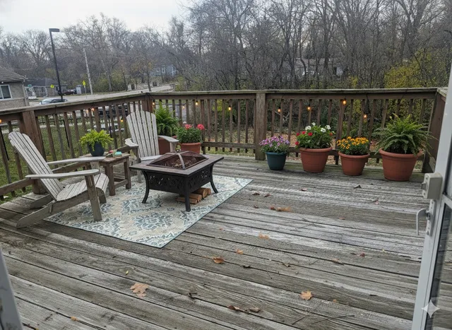 a view of a deck with chairs and wooden floor
