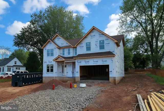 a front view of a house with yard and garage