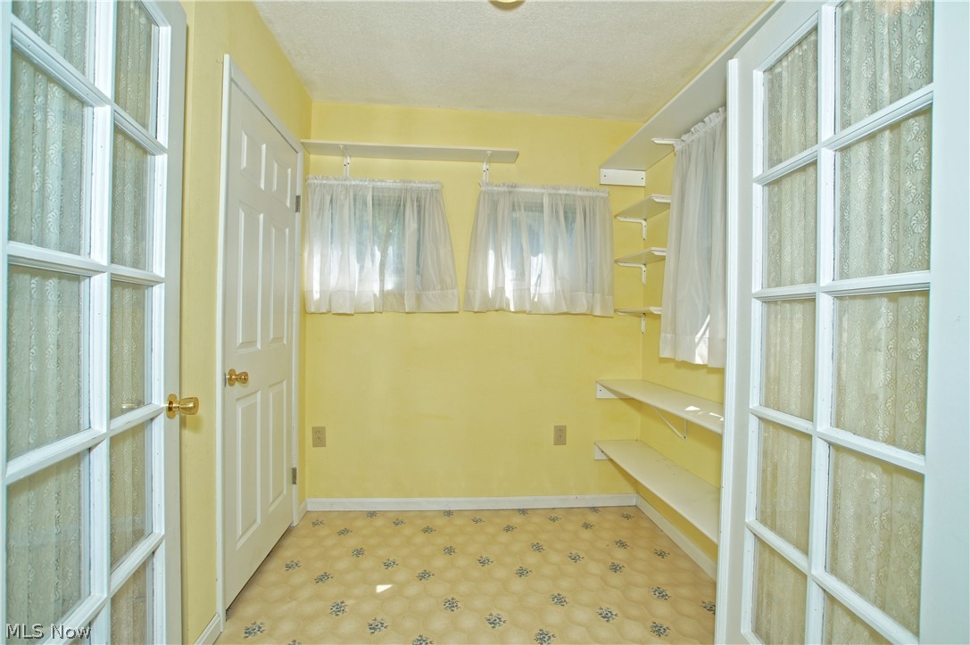 2586 County Line Road Madison, OH 44057 - Photo 13 of 31 This cheerful office space/craft room has loads of storage and French doors for privacy.