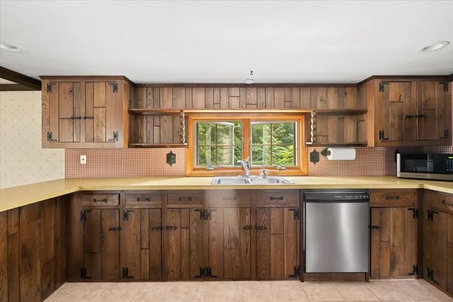 a kitchen with a sink window and cabinets
