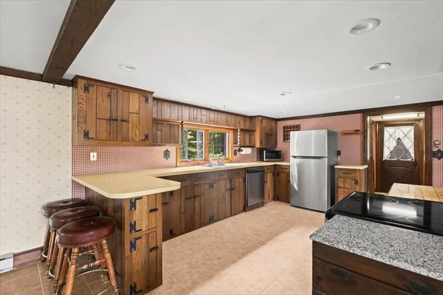 a kitchen with a sink refrigerator and cabinets