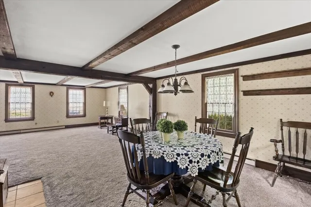 a view of a dining room with furniture and window