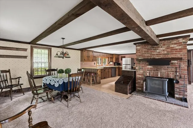 a living room with furniture a fireplace and wooden floors