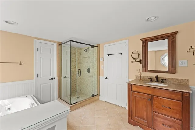 a bathroom with a double vanity sink mirror and shower