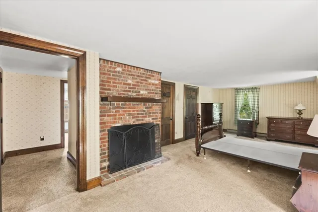 a bedroom with furniture and a fireplace