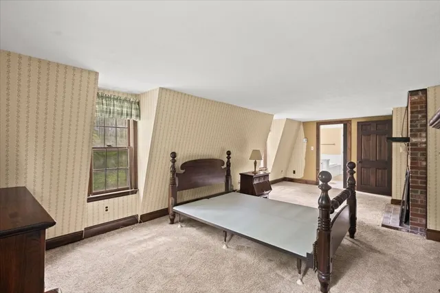 a bedroom with a bed and a large window