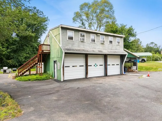 a view of house with outdoor space and parking