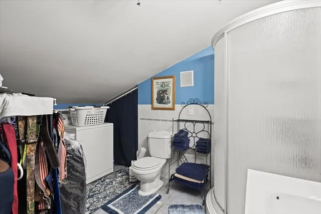 a bathroom with a toilet and a shower