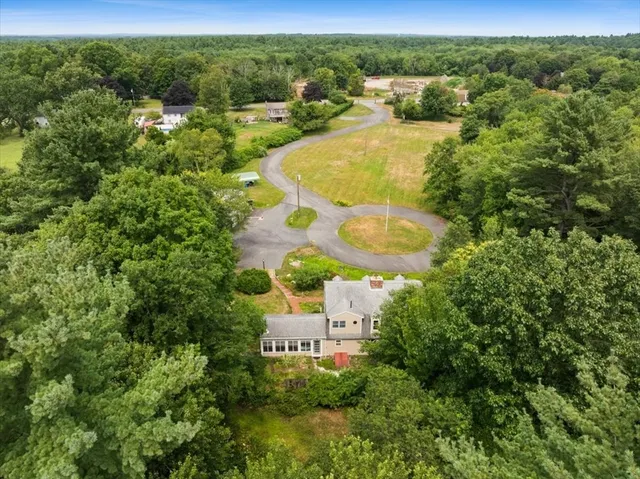 an aerial view of residential house with outdoor space and swimming pool