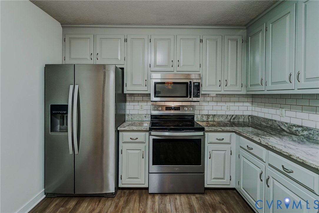 3820 Mt Pleasant Road Providence Forge, VA 23140 - Photo 6 of 40 a kitchen with cabinets stainless steel appliances and wooden floor