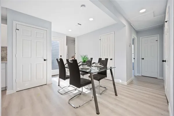 a view of a dining room with furniture and wooden floor