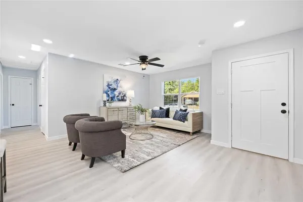 a living room with furniture and a wooden floor