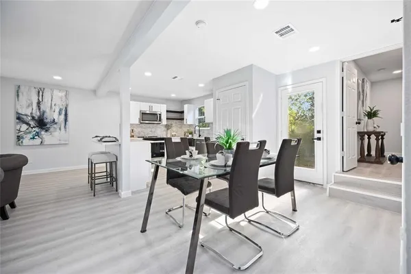 a view of a dining room with furniture and wooden floor
