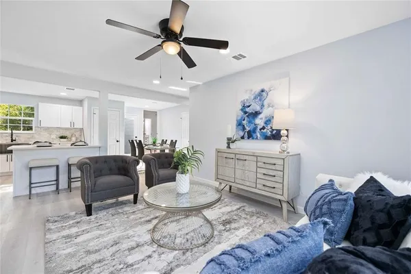 a living room with furniture and a dining table