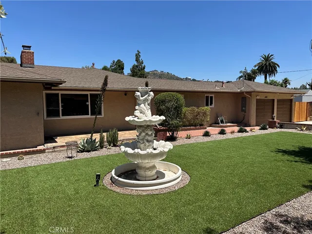 a front view of a house with a yard fire pit and outdoor seating