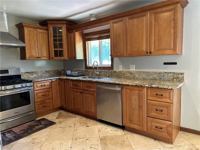a kitchen with stainless steel appliances granite countertop a sink stove and cabinets
