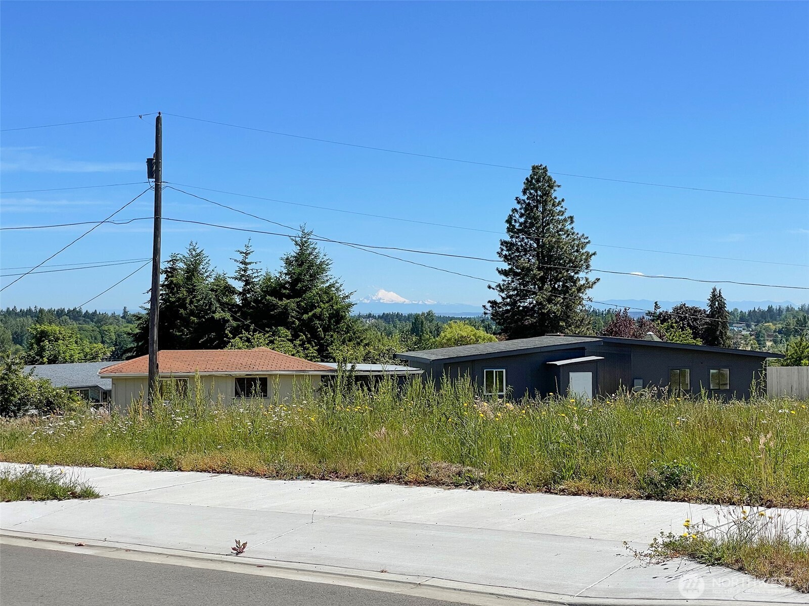 842 South Still Road Sequim, WA 98382 - Photo 2 of 13 a view of a lake with a house in the background