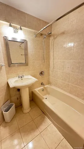 a bathroom with a sink mirror toilet and bathtub