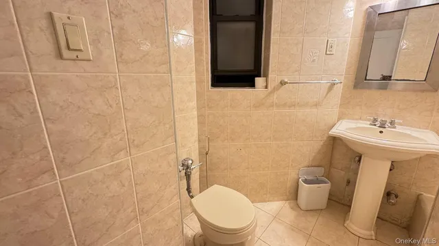 a white toilet sitting next to a bathroom sink