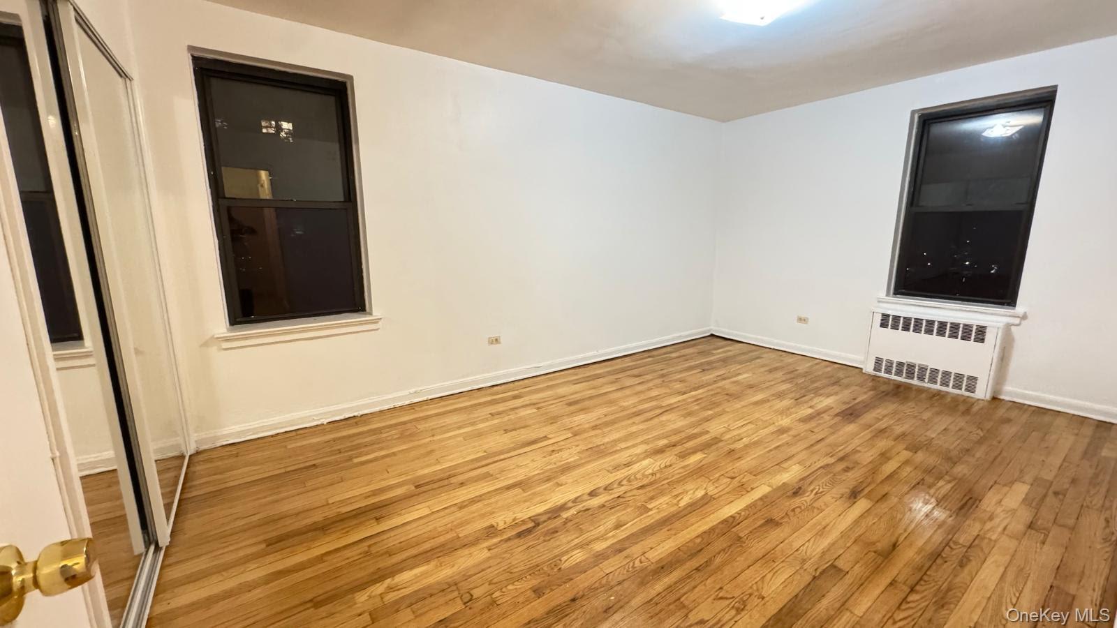 65-35 108th Street, Unit B15 Queens, NY 11375 - Photo 9 of 13 a view of an empty room with wooden floor and closet