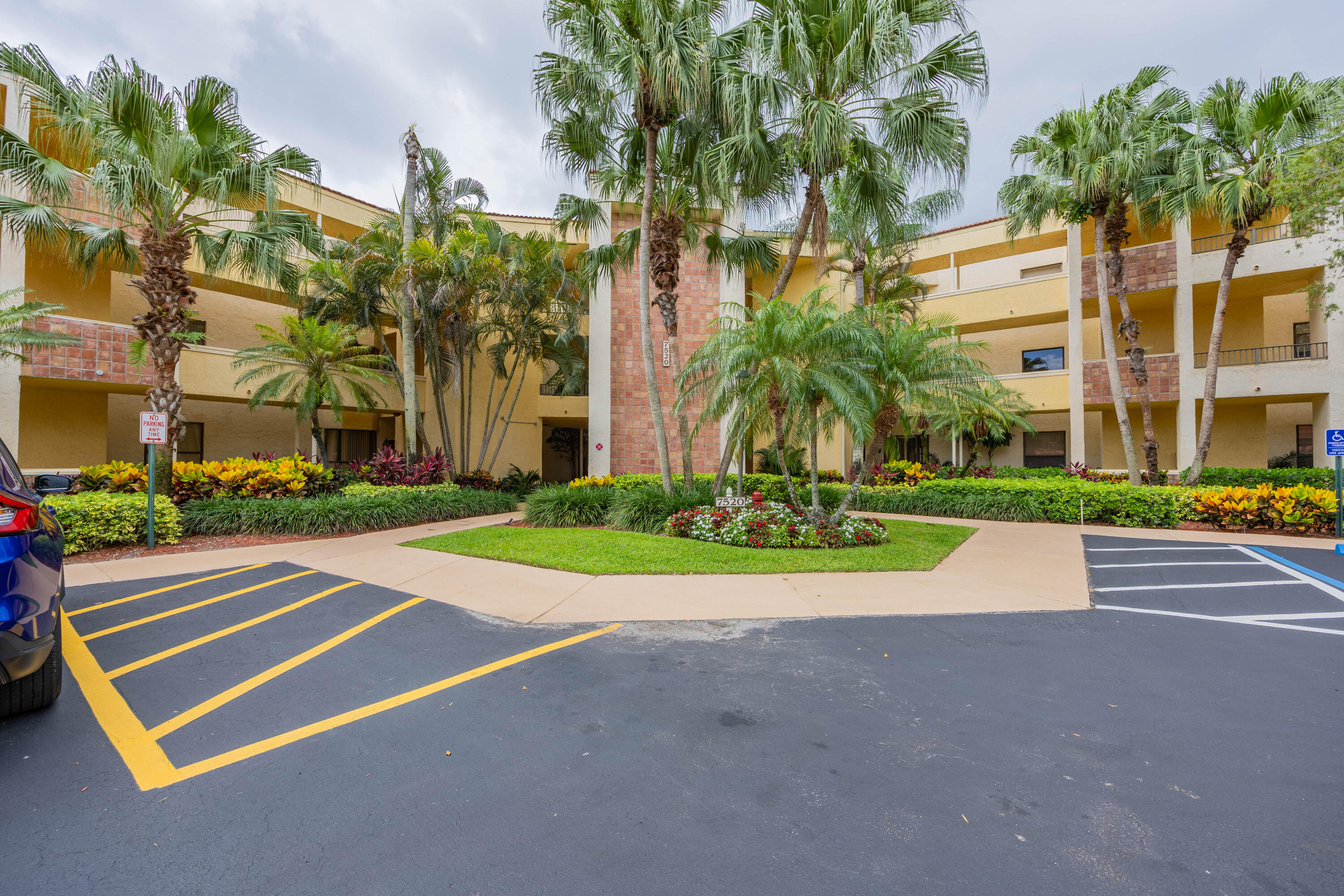 7520 La Paz Boulevard, Unit 104 Boca Raton, FL 33433 - Photo 8 of 56 a view of a tall building with a yard