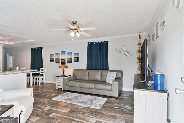 a living room with furniture and a chandelier