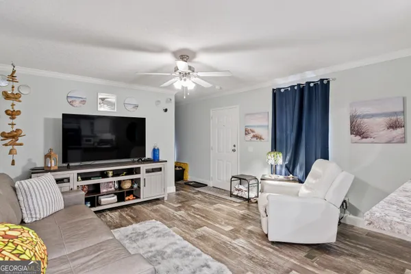 a living room with furniture and a flat screen tv