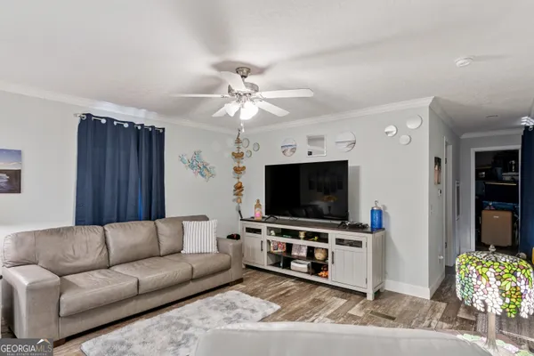 a living room with furniture and a flat screen tv