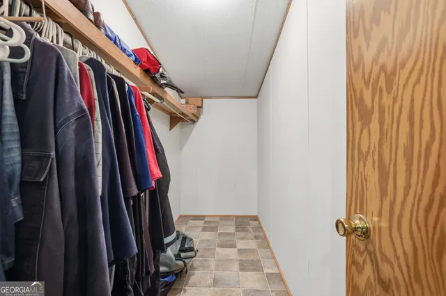 a view of walk in closet with clothes