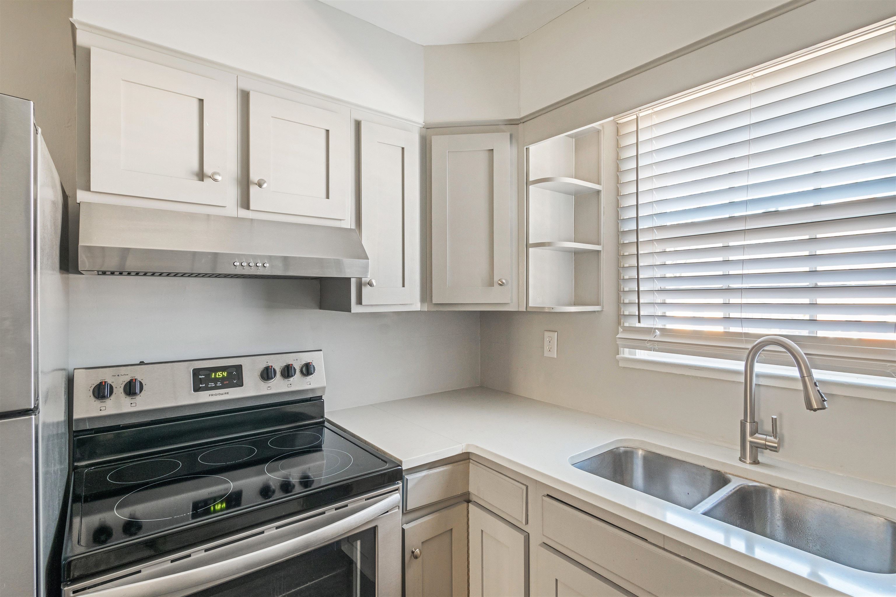 3753 Friar Tuck Road Memphis, TN 38111 - Photo 11 of 23 a kitchen with white cabinets and a stove top oven