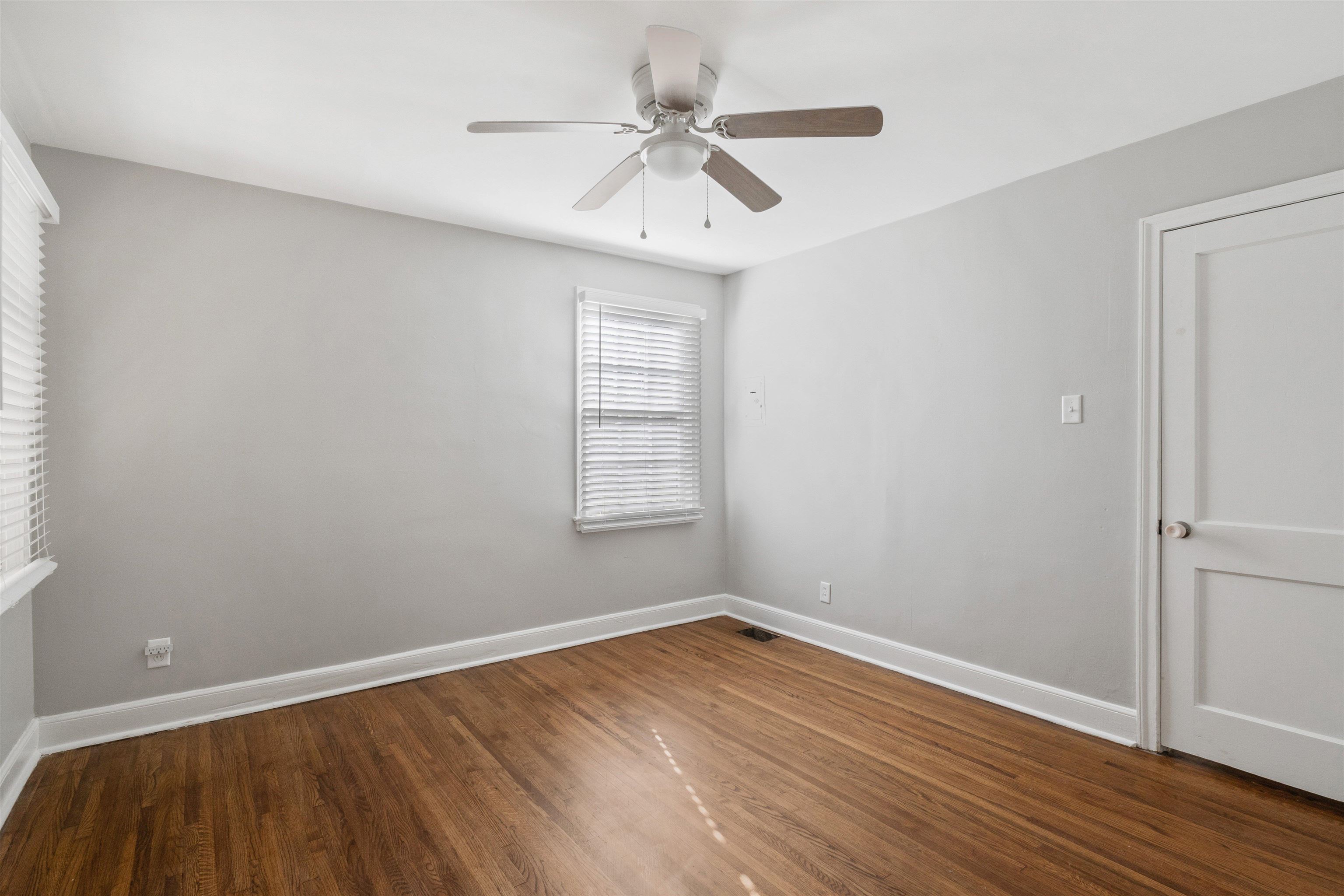 3753 Friar Tuck Road Memphis, TN 38111 - Photo 12 of 23 wooden floor in an empty room with a window