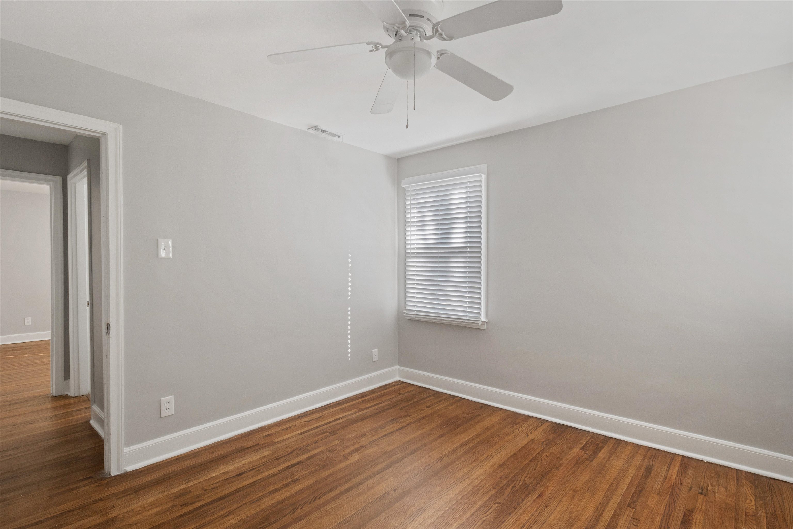 3753 Friar Tuck Road Memphis, TN 38111 - Photo 16 of 23 a view of an empty room with wooden floor and a window