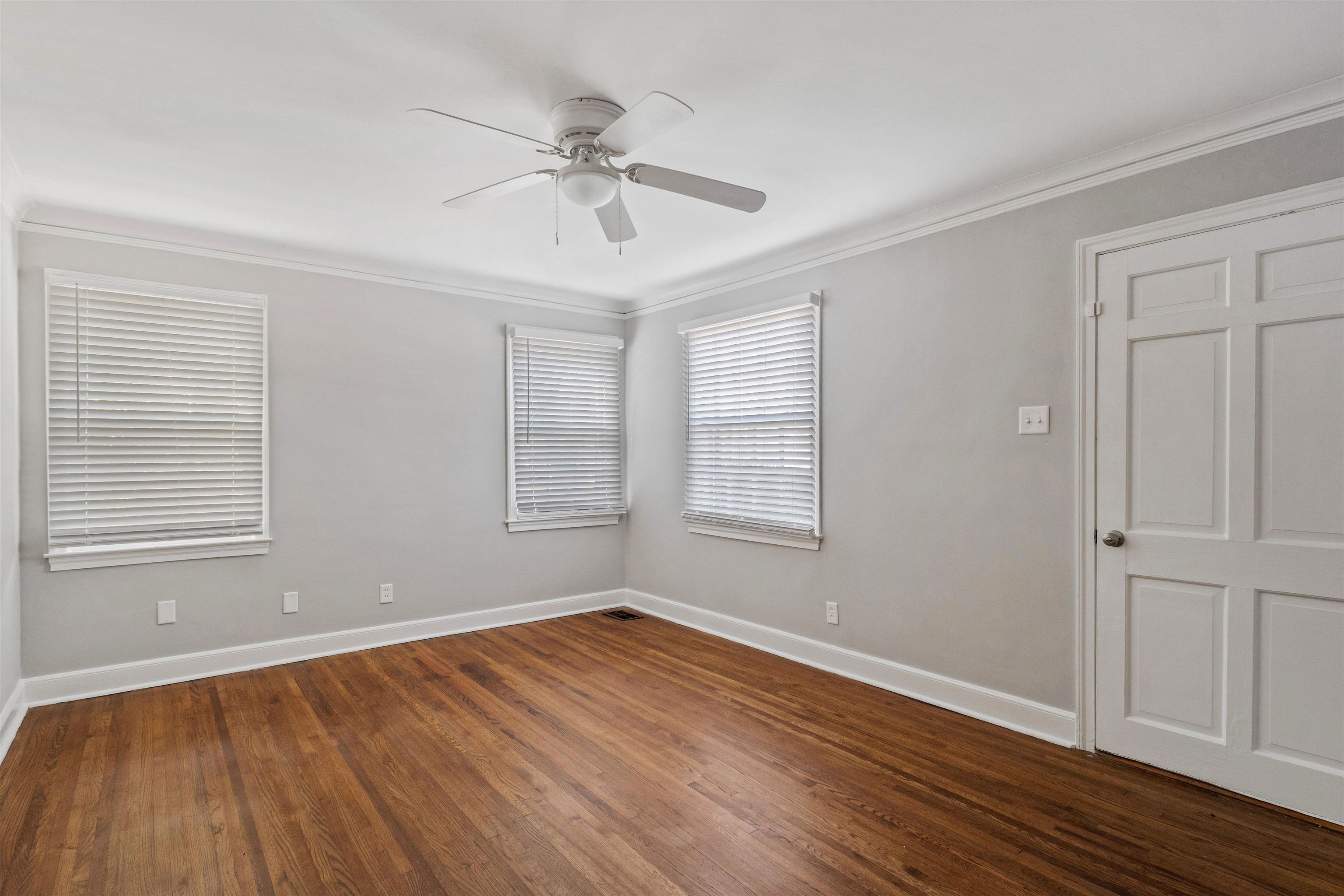 3753 Friar Tuck Road Memphis, TN 38111 - Photo 5 of 23 an empty room with wooden floor fan and windows