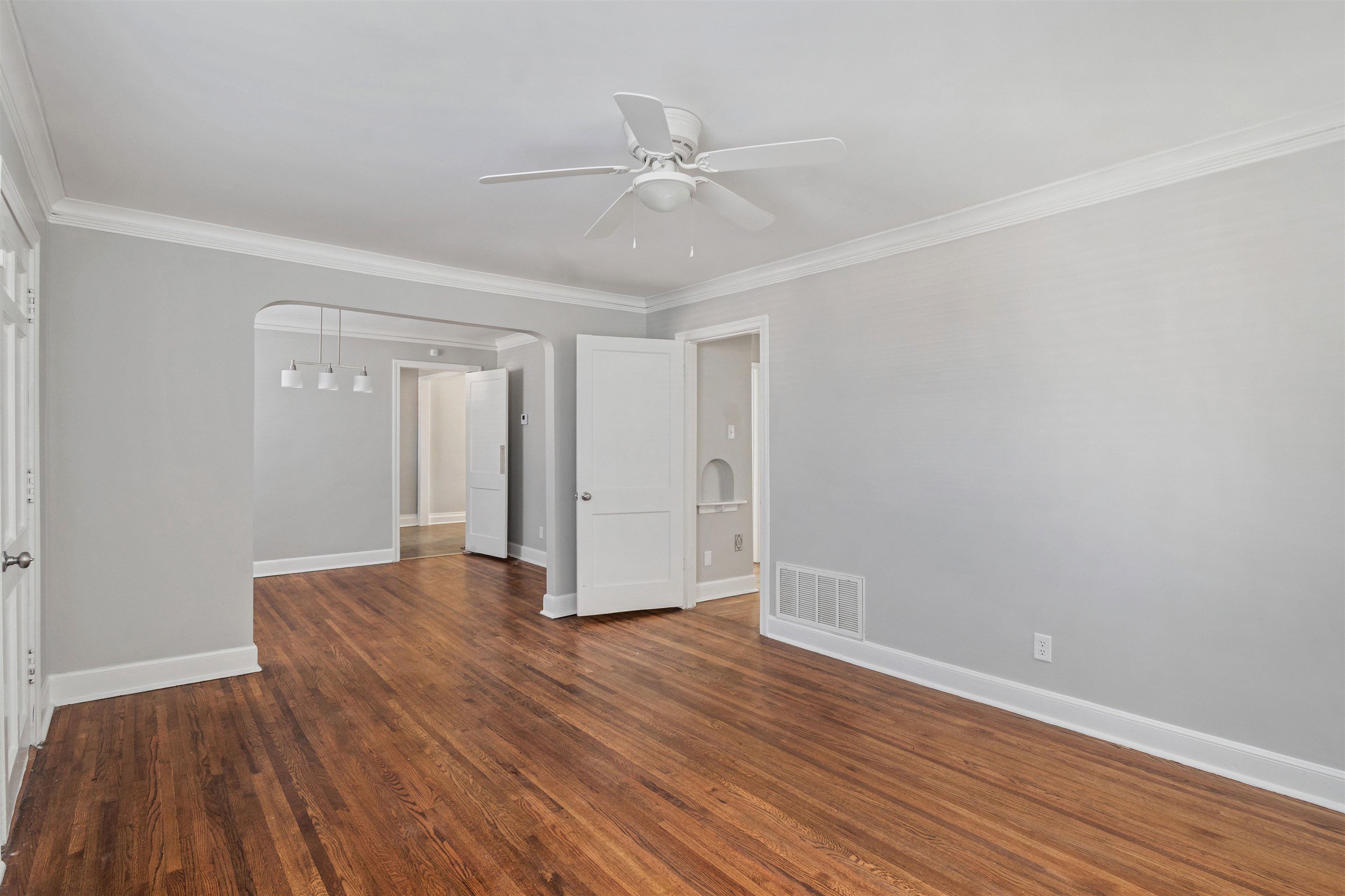 3753 Friar Tuck Road Memphis, TN 38111 - Photo 8 of 23 a view of an empty room with wooden floor and a ceiling fan