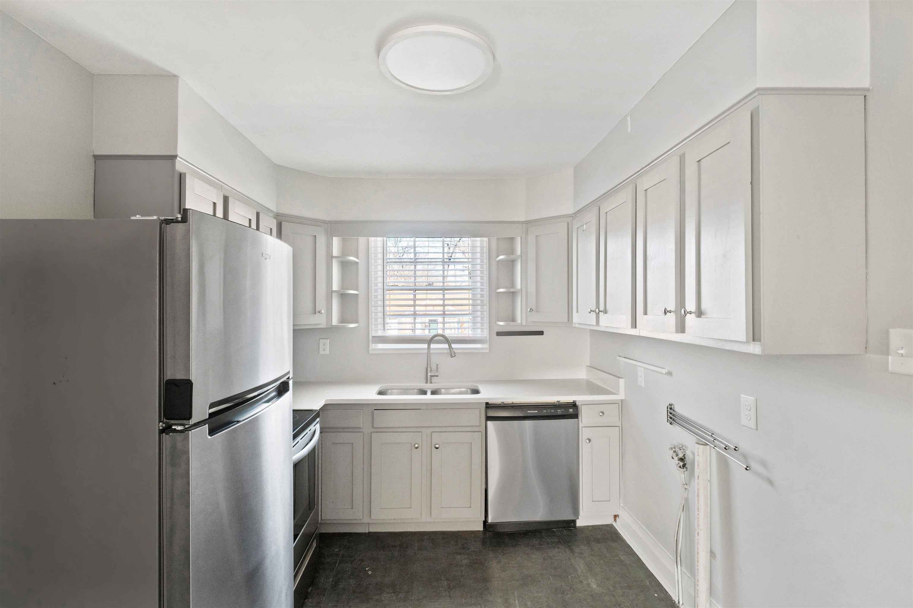 3753 Friar Tuck Road Memphis, TN 38111 - Photo 9 of 23 a view of a kitchen with white cabinets washer and dryer