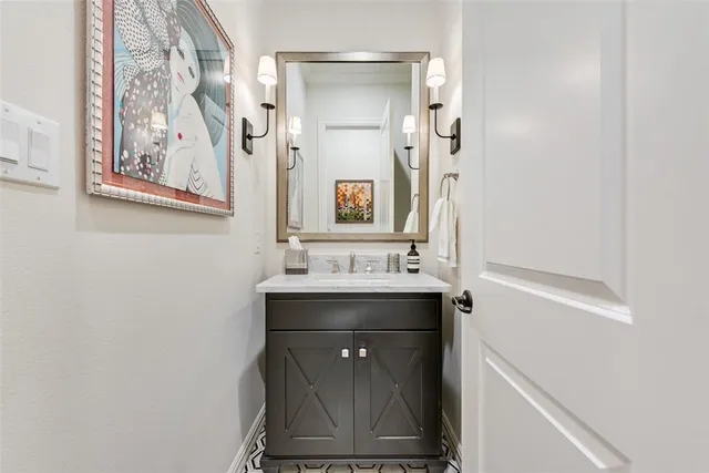 a bathroom with a sink a mirror and a vanity