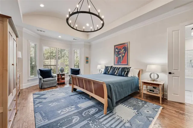 a bedroom with a bed and dresser with mirror