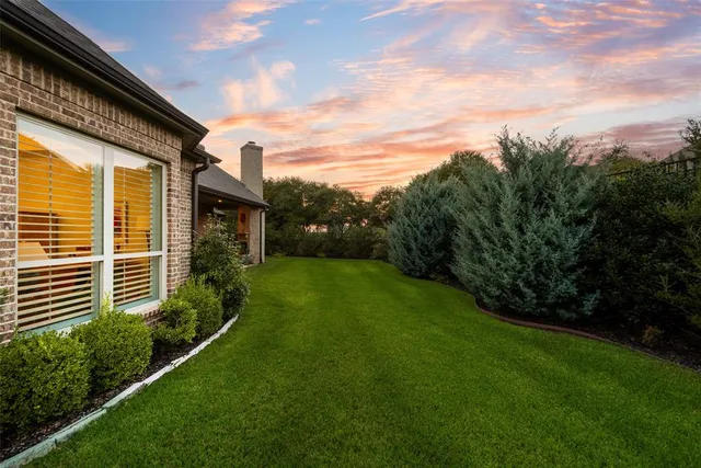 a view of a backyard with table and chairs and potted plants