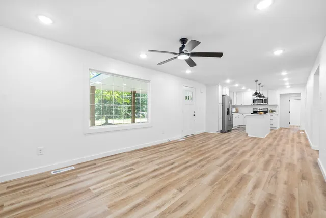 a view of a bedroom with a bed and a window