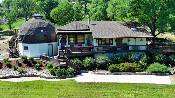 a view of a house with a yard and sitting area