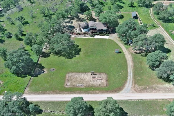 an aerial view of a residential houses with outdoor space and street view