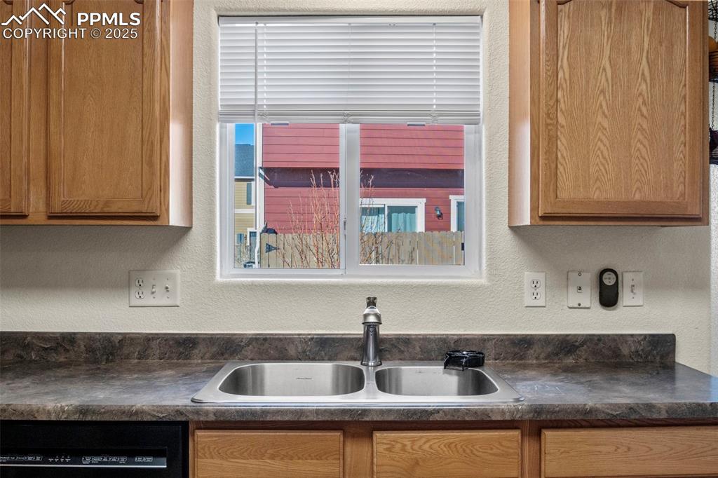 4806 Rusty Nail Point, Unit 101 Colorado Springs, CO 80916 - Photo 11 of 39 a kitchen with stainless steel appliances granite countertop a sink and cabinets