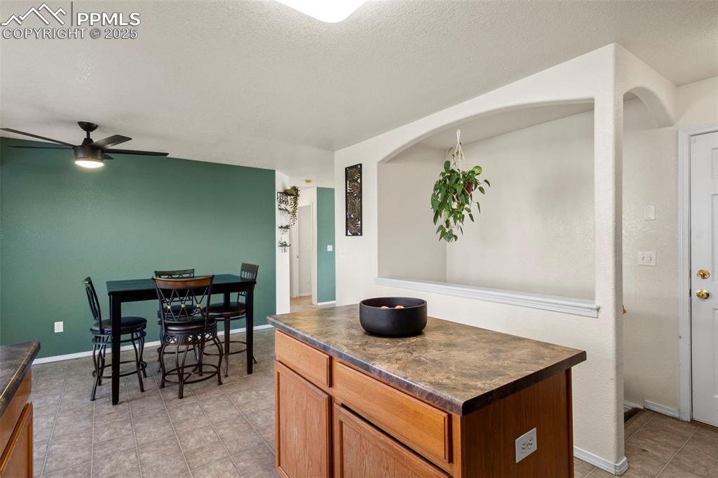 4806 Rusty Nail Point, Unit 101 Colorado Springs, CO 80916 - Photo 12 of 39 a kitchen with a table and chairs in it