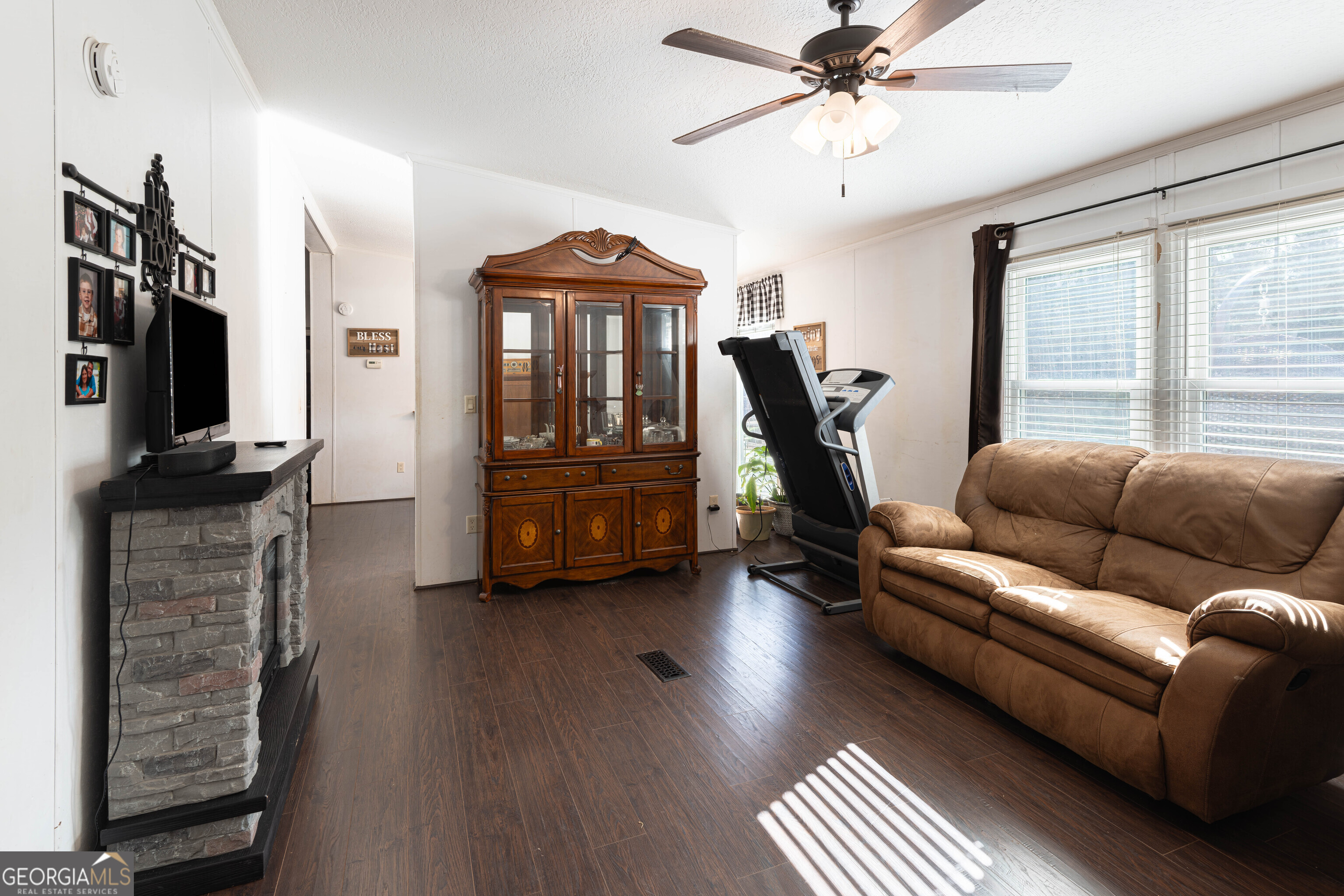 161 Cherokee Trail Forsyth, GA 31029 - Photo 16 of 32 a living room with furniture a ceiling fan and a window