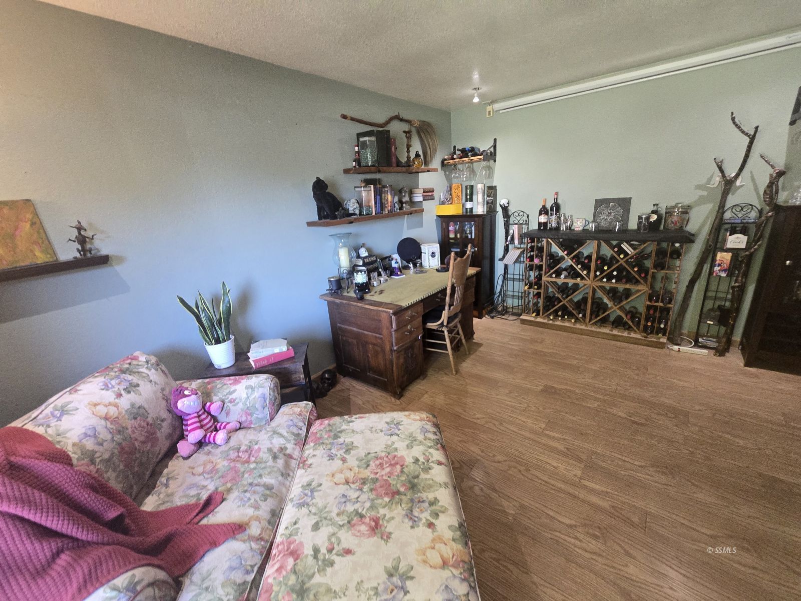 201 East Benson Avenue Ridgecrest, CA 93555 - Photo 5 of 35 a bedroom with furniture and a wooden floor