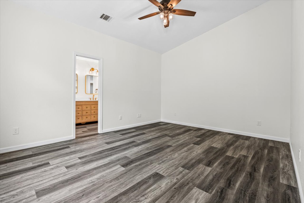 4004 Danli Lane Austin, TX 78749 - Photo 31 of 40 a view of a livingroom with wooden floor and a ceiling fan