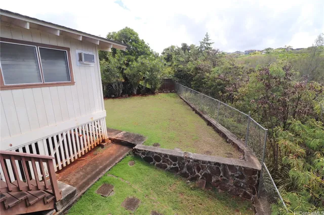 a view of a backyard with wooden fence