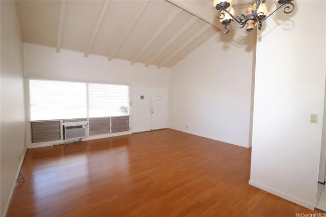 a view of a livingroom with wooden floor and a ceiling fan