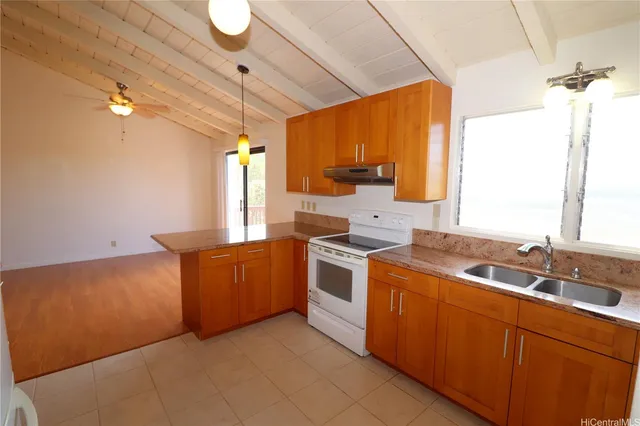 a kitchen with stainless steel appliances granite countertop a sink a stove and a refrigerator